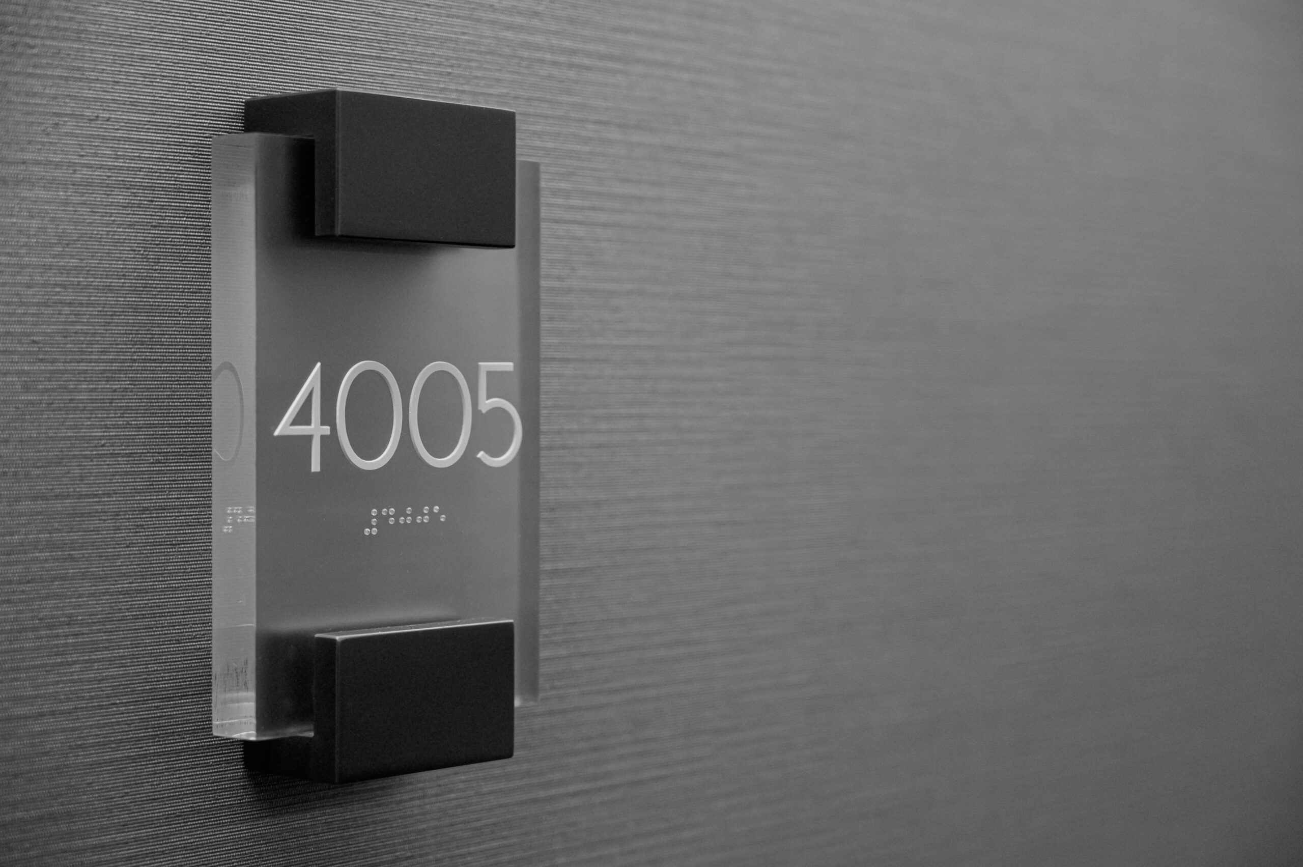 Elegant monochromatic room number sign with a sleek and minimalist design.